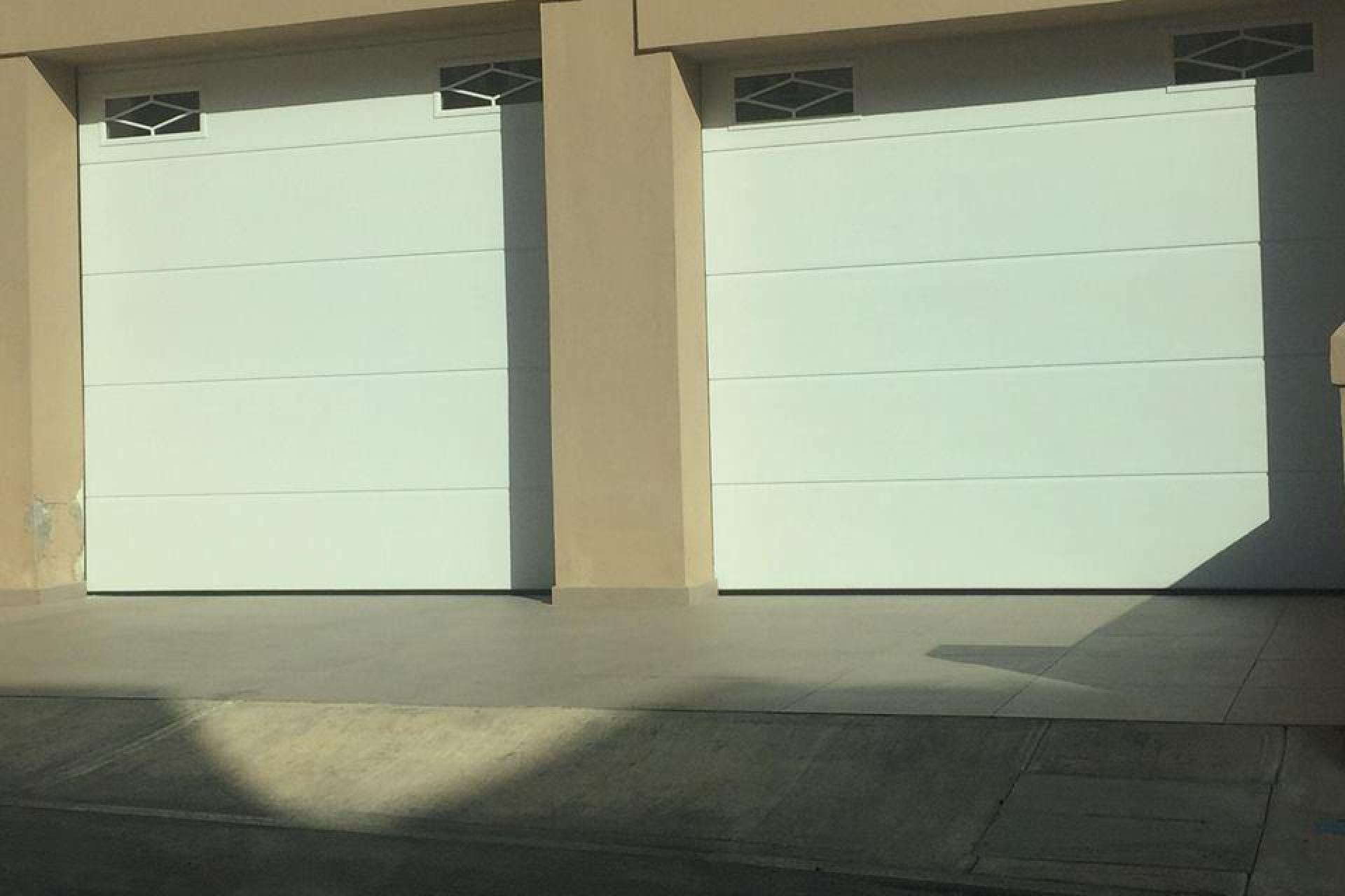 rhombus windows on top, garage doors Malta